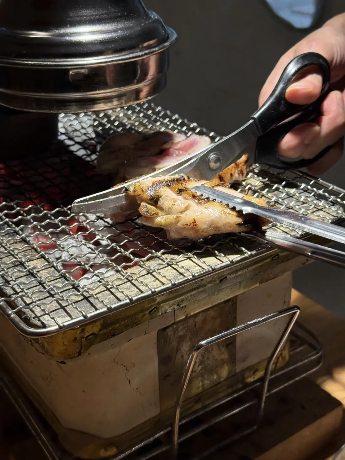店员用剪刀在烤网上剪肉